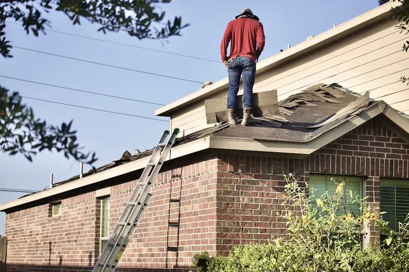 Professional roofer working on a residential roof in Miller Shaft